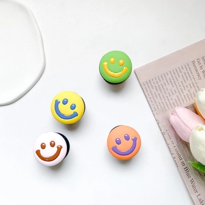 Detailed view of colorful smiley face phone sockets in green, yellow, pink and orange colors