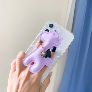 Detail view of purple leather animal phone grip with fine stitching and a gold charm