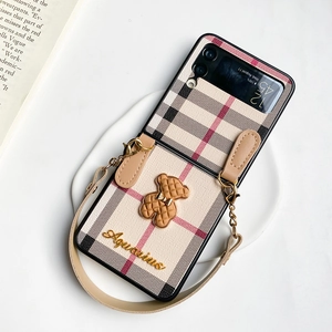 Detail of Samsung Galaxy Z Flip case featuring vintage beige plaid and 3D brown bear charm