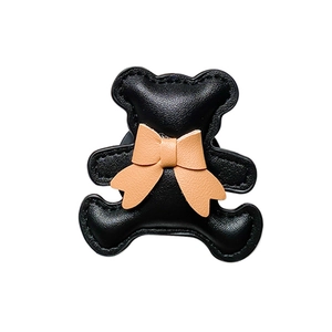 3D cartoon bear phone stand with pink bow made of black leather texture material
