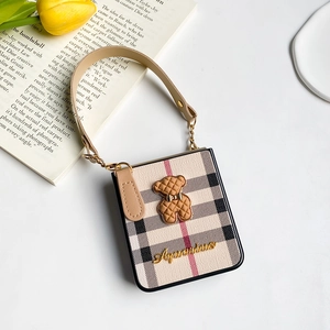 Detail of checkered case for Samsung Z Flip 4 with 3D bear and leather handle