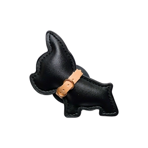 Black leather dog phone stand with litchi grain and gold buckle on white background