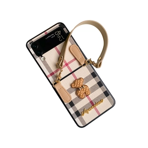 Classic plaid Samsung Z Flip 4 case with leather hand strap and teddy bear charm