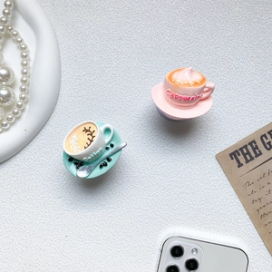 Creative 3D coffee cup phone grip featuring detailed latte art on a textured surface