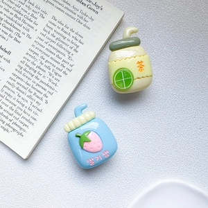 Close-up of cute cartoon lemon tea and strawberry jam resin phone sockets on white background