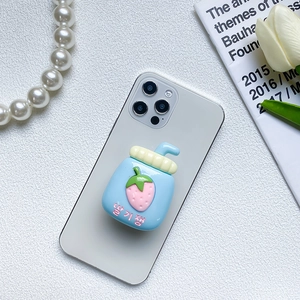 Cute 3D strawberry jam jar collapsible phone grip stand on a white smartphone
