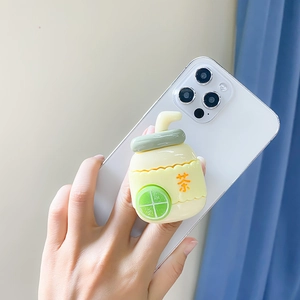 Detail of 3D lemon tea bottle phone socket grip on white smartphone held by a hand