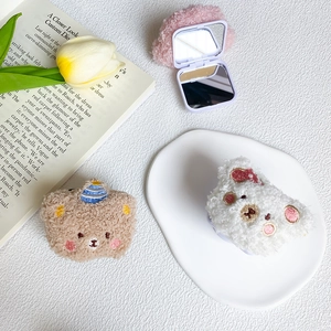 Detail of plush bear mirror featuring soft lamb wool fabric and cute animal embroidery