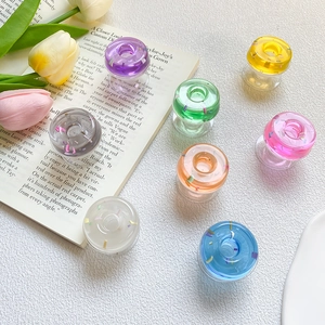 Close-up of colorful translucent donut-shaped resin phone grips in various vibrant colors