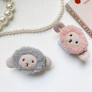 Detail of plush lamb phone stand featuring cute 3D ears and soft sheep wool texture