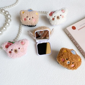 Detail of four colorful plush bear folding mirrors with lamb wool texture and compact design