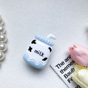 Detailed view of a cute milk bottle silicone phone grip with blue wave base and cow pattern