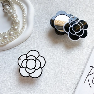 Detailed view of camellia flower phone socket with integrated vanity mirror and flip design