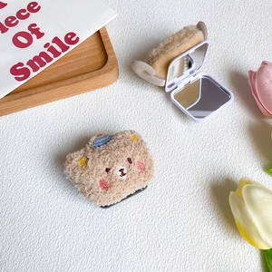 Detail of cute bear plush folding makeup mirror with soft texture and internal mirror