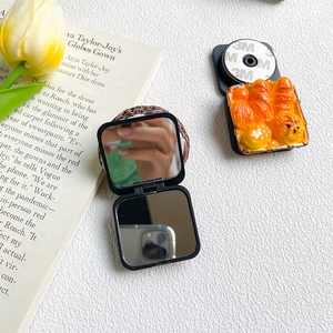 Detail showing foldable mirror phone stand with realistic mini 3D bakery bread decor