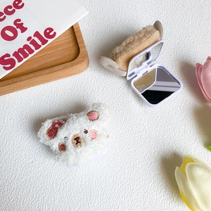Detail view of plush bear foldable mirror showing closed and open states with dual lenses