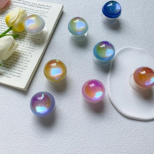 Macro view of colorful laser glitter phone grip sockets on a minimalist white background