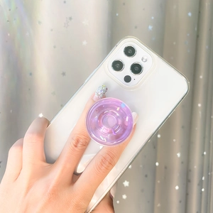 Purple transparent donut phone socket with colorful sequins on a white phone