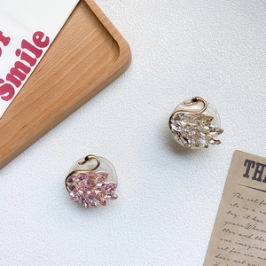 Close-up of elegant swan phone holders with pink and champagne crystal rhinestones