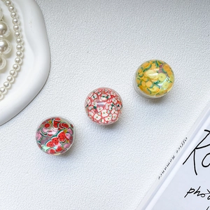 Detail of three resin phone grips with realistic watermelon, apple and lemon slices inside