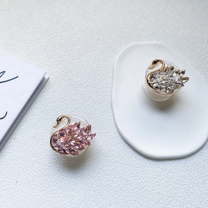 Detailed view of swan-shaped phone socket featuring pink and clear rhinestones