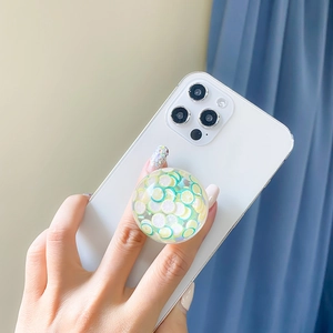 Collapsible resin phone grip with fresh lemon slice pattern on a smartphone back