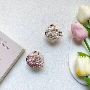 Luxurious swan-shaped crystal phone sockets in silver and pink with metallic accents