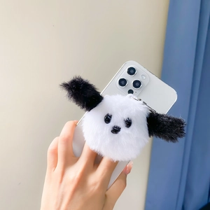 Cute panda plush phone grip and holder with soft fur on a white smartphone