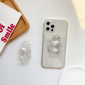 Macro shot of 3D transparent astronaut phone stand on clear minimalist case