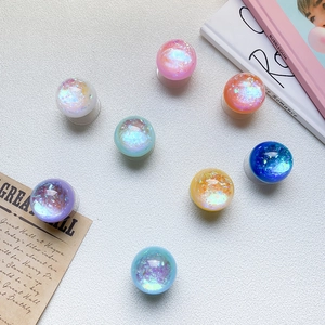 Flat lay of colorful glitter resin phone grips with aurora sequins in 8 vibrant shades