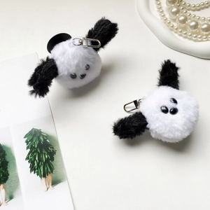 Close-up of cute plush puppy phone grips with metal lobster clasps and furry texture
