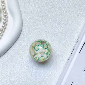 Detail showing transparent resin phone grip with realistic lime and lemon slices inside