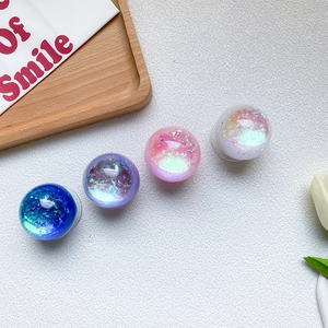 Detail of four holographic crystal ball phone grips showing shimmering glitter texture