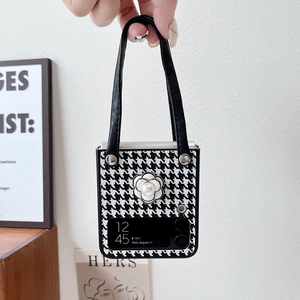 Detail of Galaxy Z Flip case with houndstooth pattern, camellia flower and leather strap
