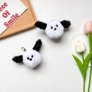 Close-up of plush dog panda phone holder charm with soft fur and silver metal hook