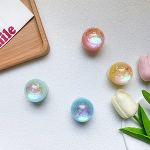 Macro detail of round iridescent glitter phone sockets in pastel pink, yellow and mint colors