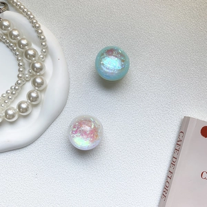Detailed close-up of iridescent crystal ball phone sockets with laser glitter fragments