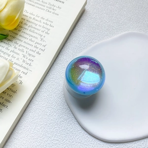 Close-up of holographic glitter resin phone socket on a tray with floral background