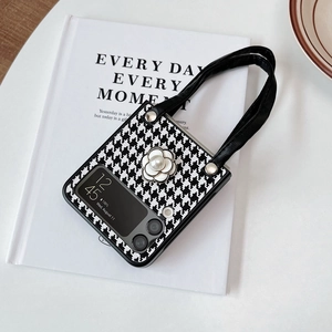 Detail of camellia flower and pearl accent on houndstooth case for Z Flip