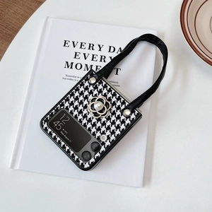 Detail of camellia flower and pearl charm on houndstooth Samsung Z Flip folding case