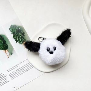Close-up of plush panda animal charm with soft white fur and silver metal lobster clasp