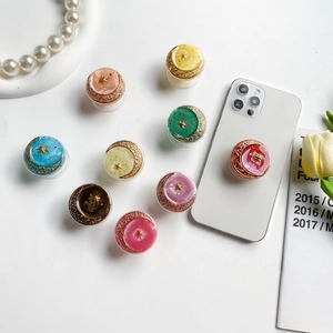 Detailed view of colorful moon and star pop-sockets on a smartphone for desk support