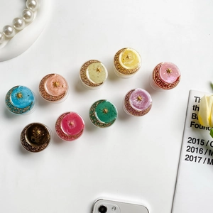 Detail of colorful phone grips with gold star and moon hollow relief in various pastel colors