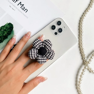 Flower-shaped phone socket holder featuring black and white houndstooth fabric design