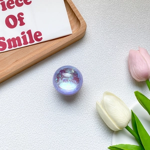 Close-up of a round laser purple glitter phone socket with holographic foil fragments