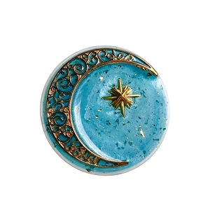 Blue resin moon star phone socket stand with gold foil details on white background