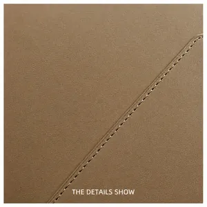 Detailed close-up of premium brown leather texture with precise diagonal stitching