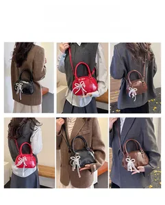 Three-way carry demonstration of vintage bowling bag with lace pearl bow charm detail