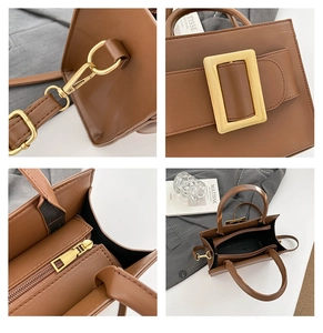 Detail view of brown faux leather bag showing gold buckle and metal zipper