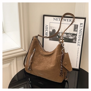 Detail view of vintage brown tote bag with silver zipper and mini envelope pouch
